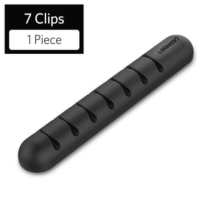 Organizador de cables de silicona con adhesivo para escritorio, veladores, y muebles en general.